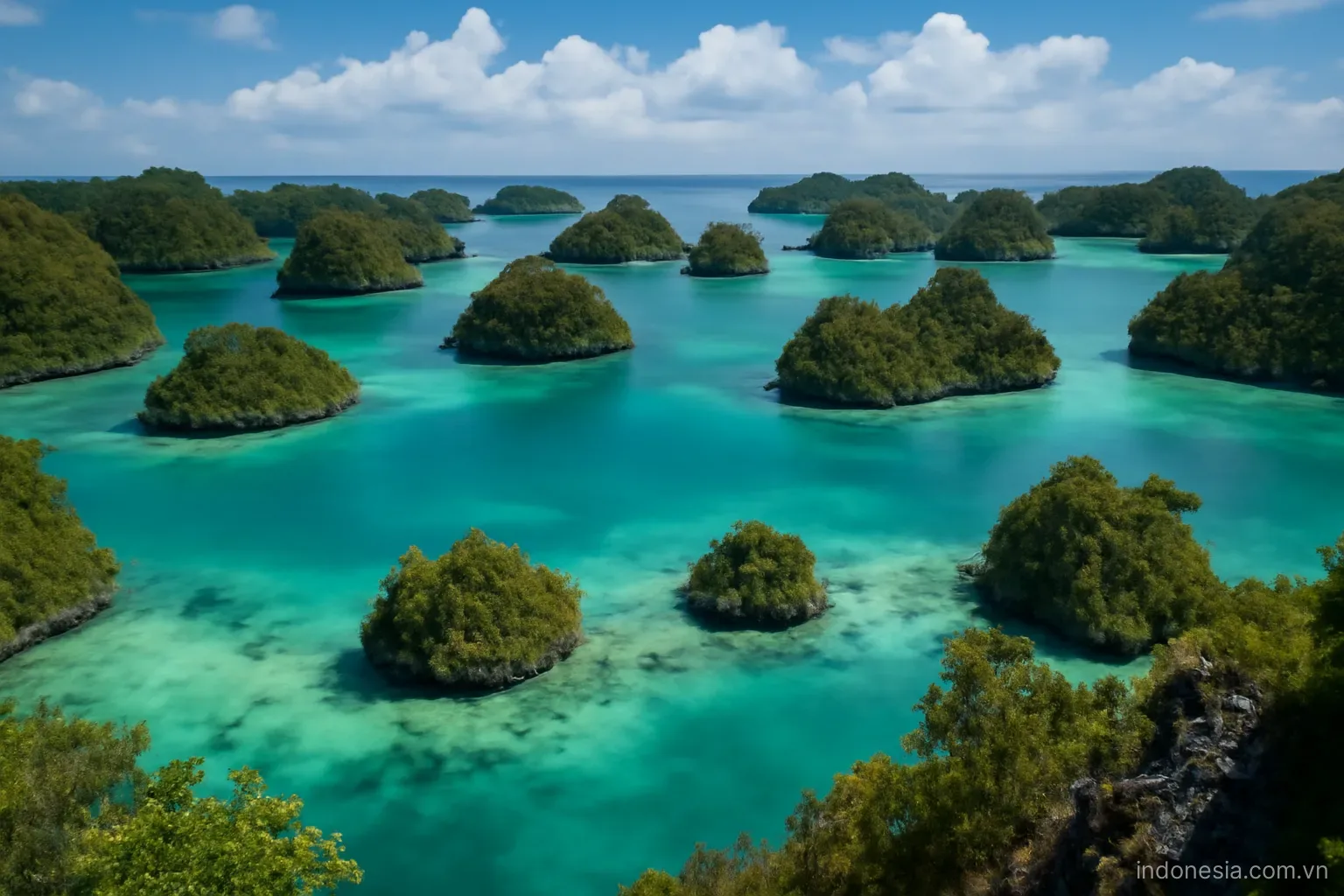 Karst islets scattered across shallow turquoise lagoons seen from a high viewpoint, wide view, no text